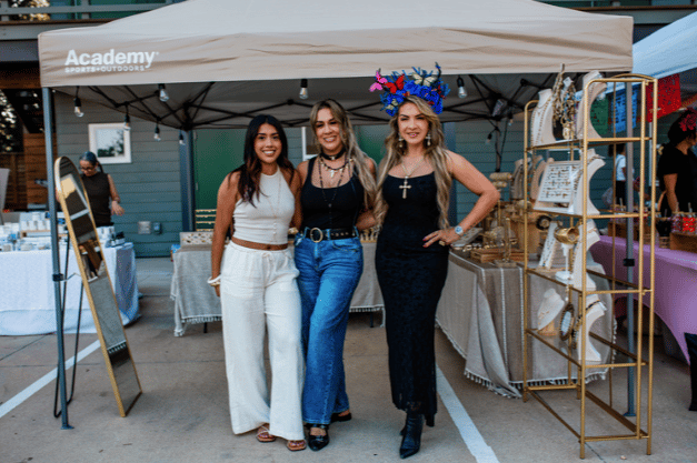 Vendors at a pop-up booth during an evening market
