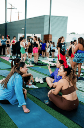 Attendees relaxing on yoga mats outdoors