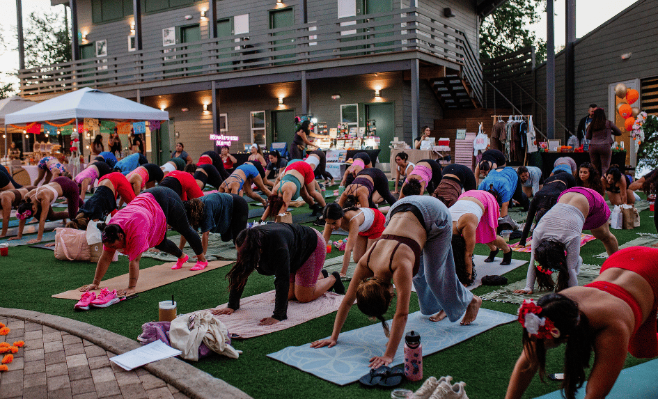 Yoga class in the courtyard with vendor booths