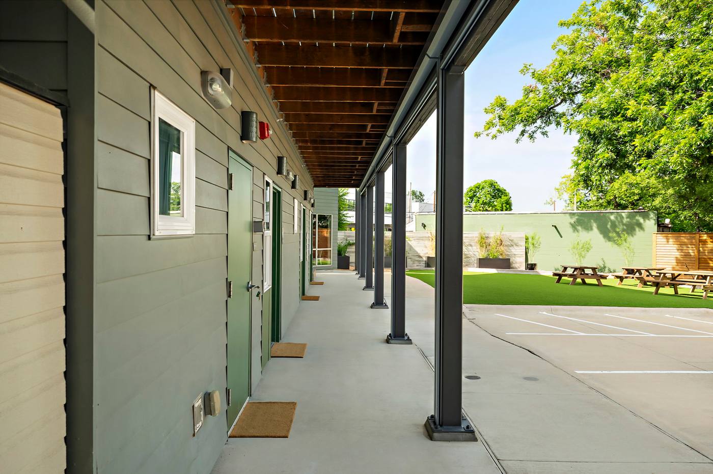The covered walkway past the room doors